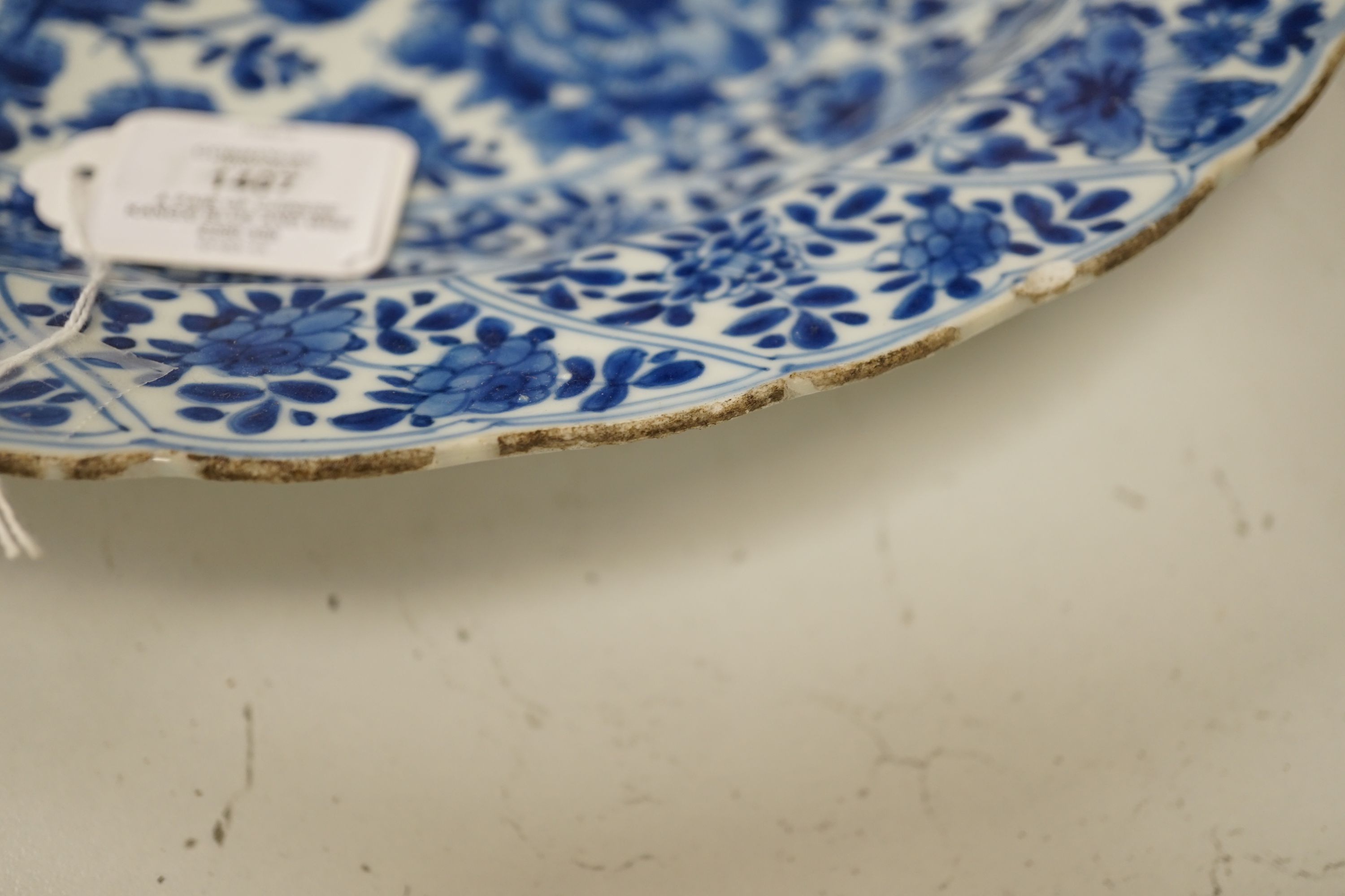 A pair of Chinese Kangxi blue and white dishes, painted with rock work and flowers, artemisia leaf marks, 37cm diameter